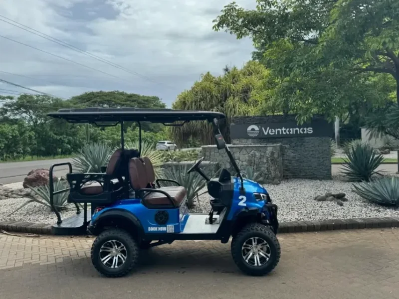Blue Go Grande golf cart parked at the Ventanas entrance in Playa Grande, Guanacaste